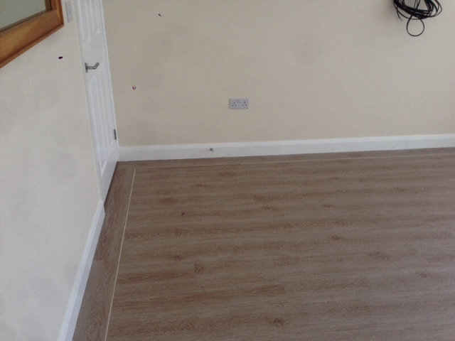 We supplied and fitted Brampton chase luxury Vinyl tile with a karndean feature strip